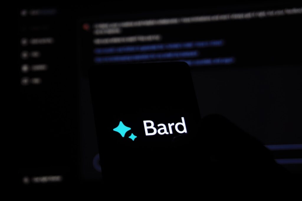 a person holding a cell phone with the word bard on it